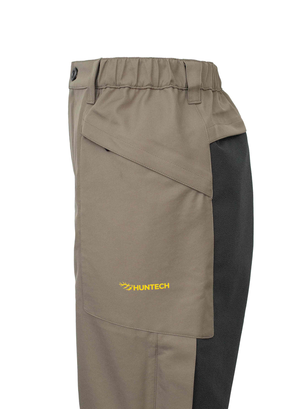 Close up of the left hand side pocket with Huntech logo in bright yellow. Also visible is the Oxford dry seat and the slightly elasticated waistband.