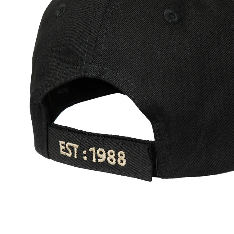Rear view of black cap showing adjustable band with 1988 embroidered in cream on it.