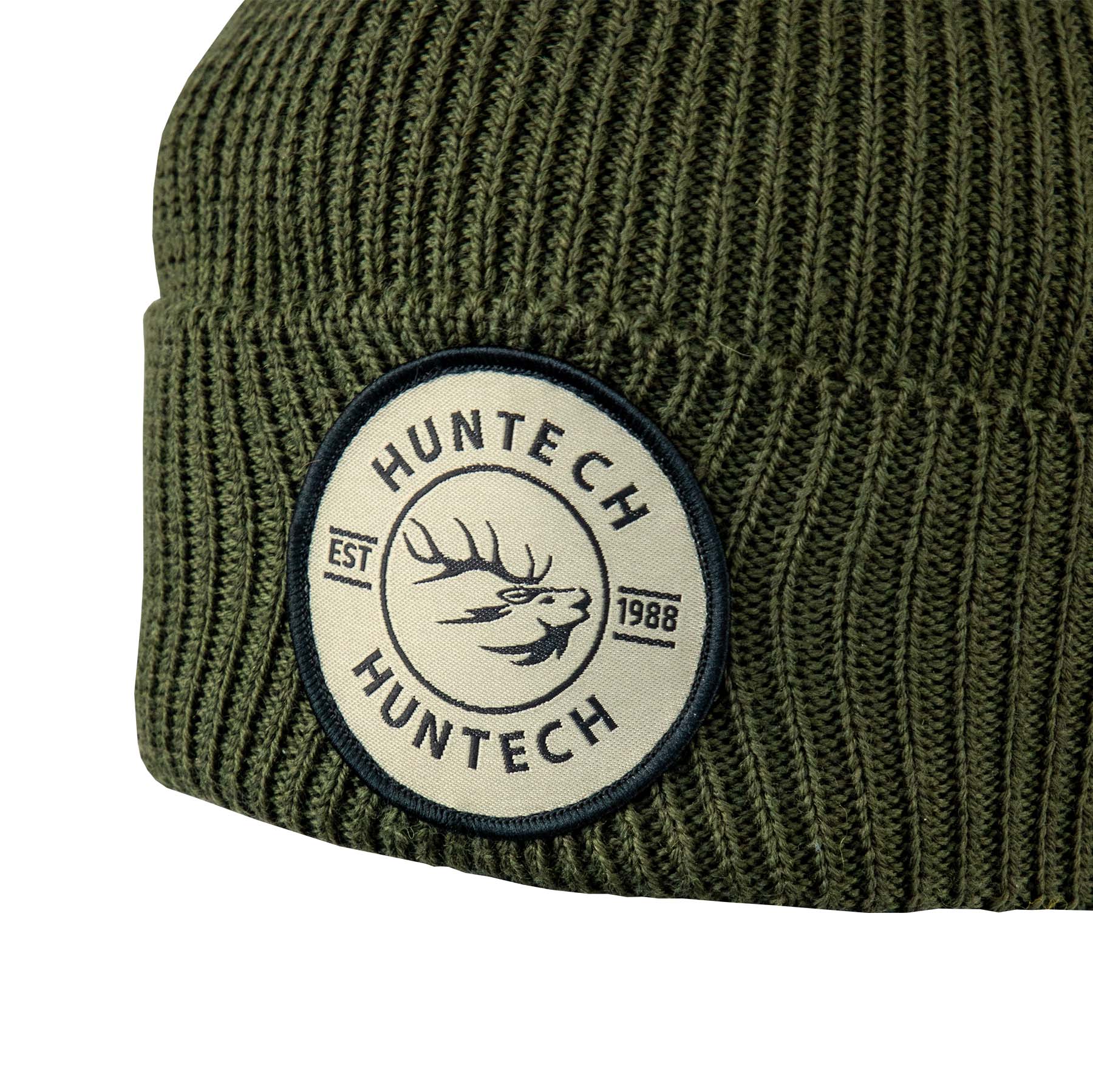 Close up of the Huntech est 1988 badge on a military green adult beanie that offers the ideal balance of natural insulation, breathability, and long-lasting wear. One size fits all with this recycled blend rib knit beanie. Ships from Australia.
