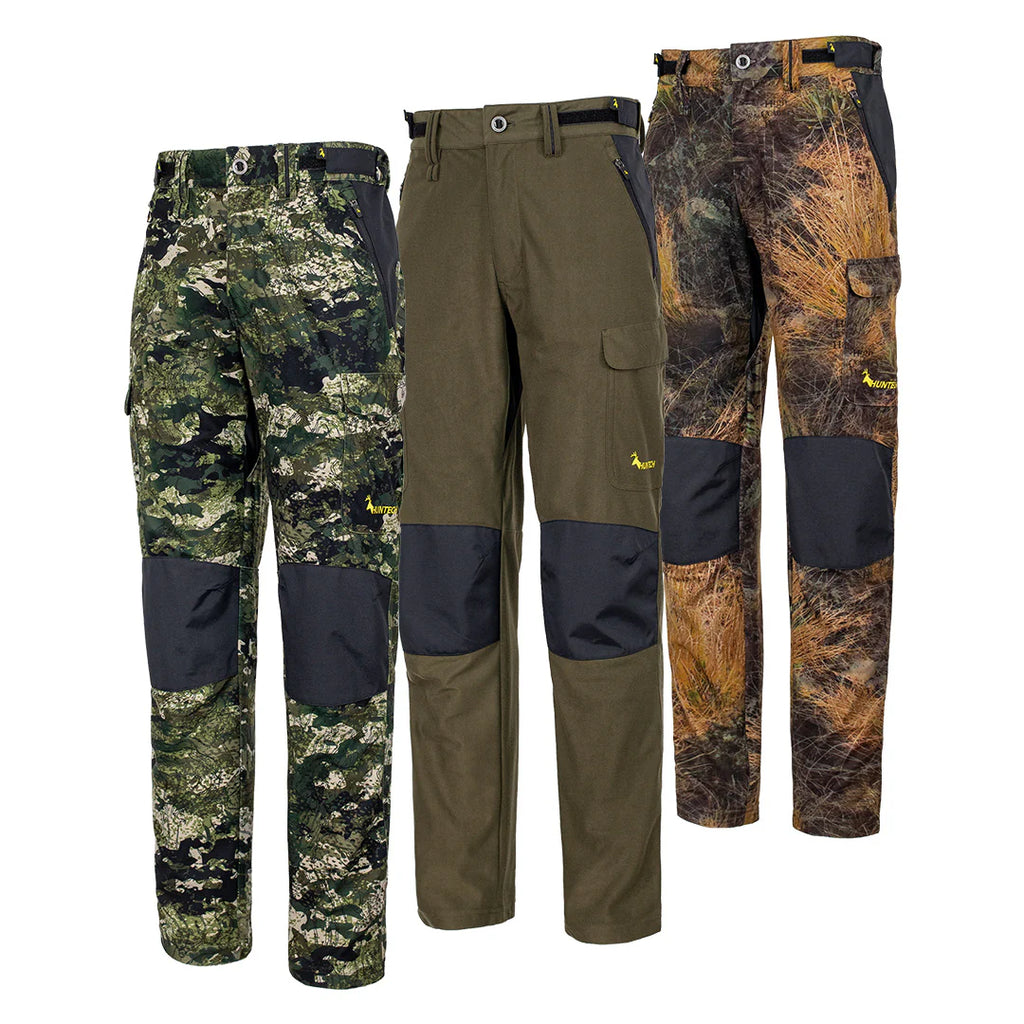 Front view of three pair of men’s mid-weight pants in a brushed tricot, with a flexible spandex crutch, a reinforced Oxford knee and internal waist adjustment system. Huntech logo appears in bright yellow just above the black Oxford knee on the left hand side. Ships from Australia. Shown left to right in kakariki camo, military green, and high-country camo.