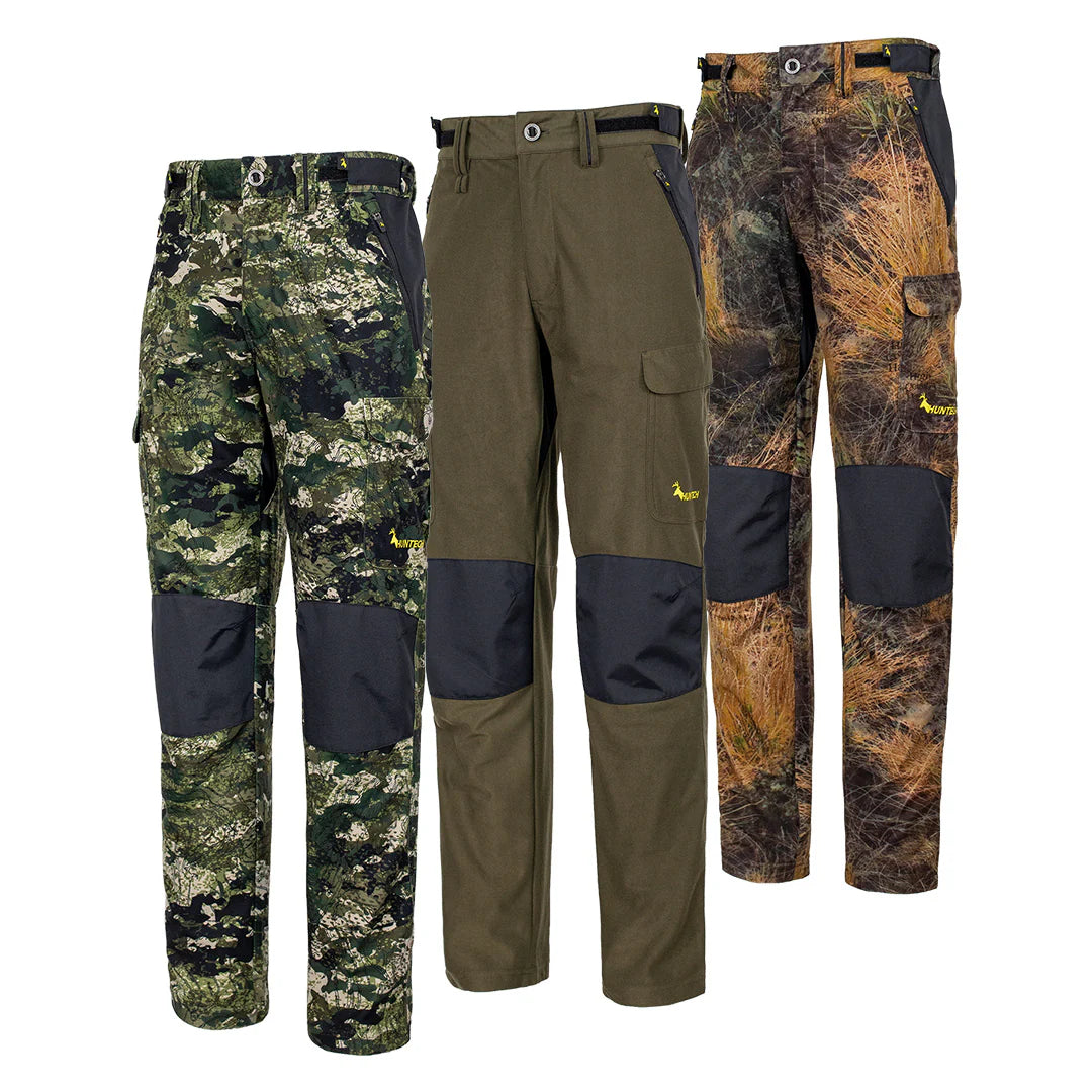Front view of three pair of men’s mid-weight pants in a brushed tricot, with a flexible spandex crutch, a reinforced Oxford knee and internal waist adjustment system. Huntech logo appears in bright yellow just above the black Oxford knee on the left hand side. Ships from Australia. Shown left to right in kakariki camo, military green, and high-country camo.