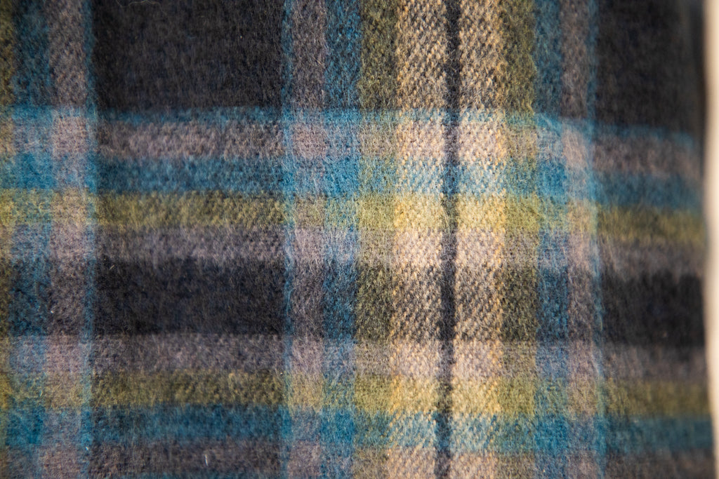 Close up of soft blue, yellow, pink and black checked jacquard cotton with a brushed finish