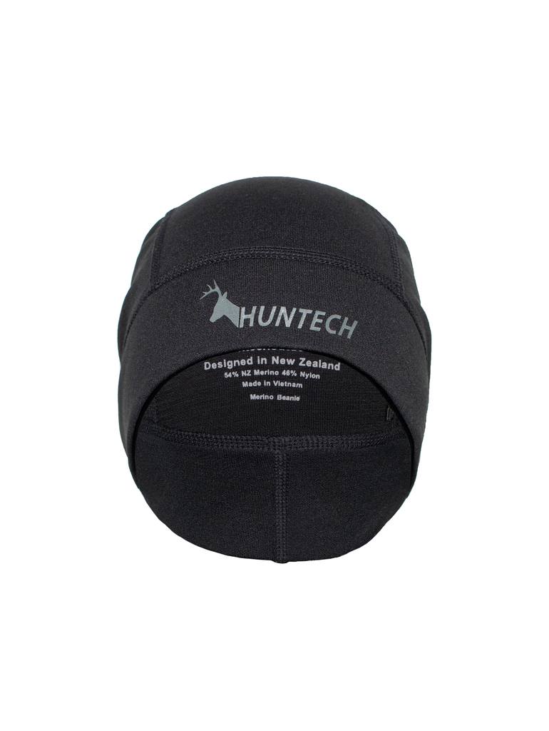 Front view of beanie designed to sit low over the ears for full coverage. It has a nylon outer for snag resistance and a smooth fleece lining that adds insulation without bulk. Shown here in black is has the Huntech logo on the front edge in a dark grey. Ships from Australia.