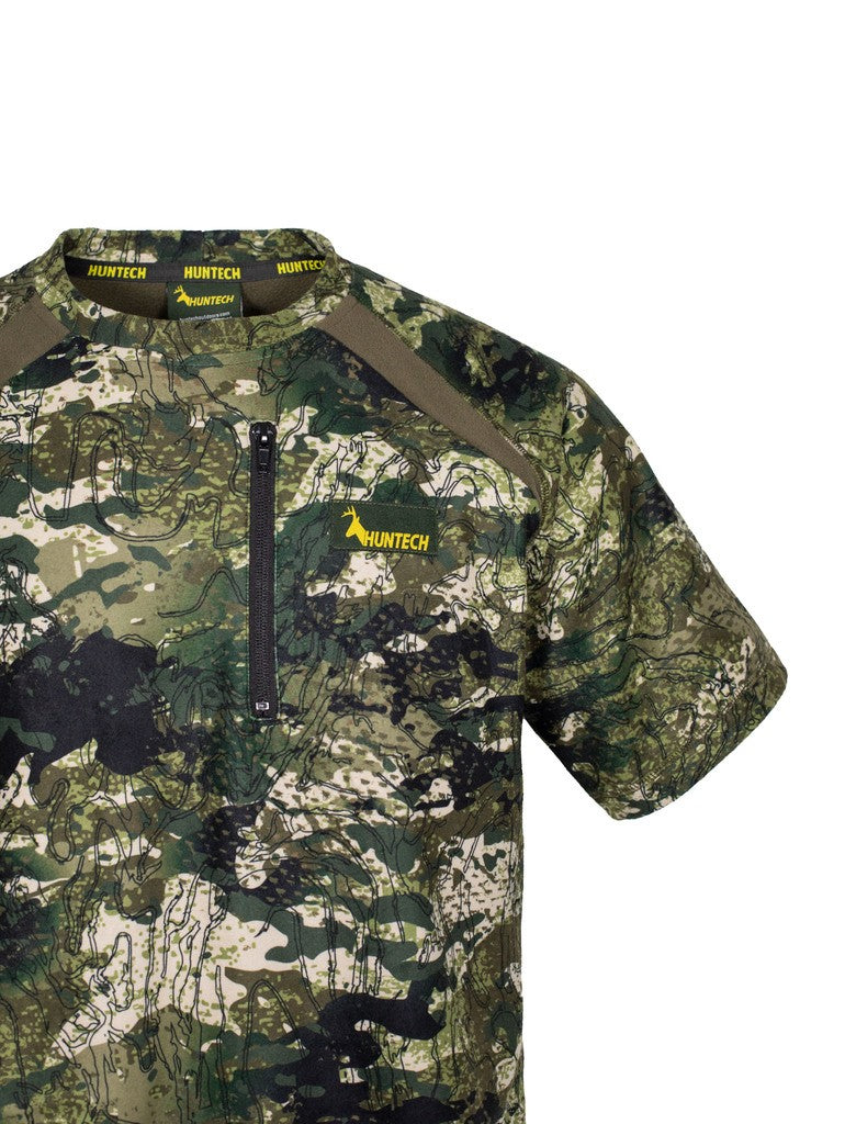 Close up of men’s bush tee in 180gsm high grade anti-pill finished fleece with standard crew neckline and is constructed using flatlock reinforced seams for strength and comfort, it features a zipped pocket and the Huntech logo on the left breast. Shown in kakariki camo pattern. Ships from Australia.