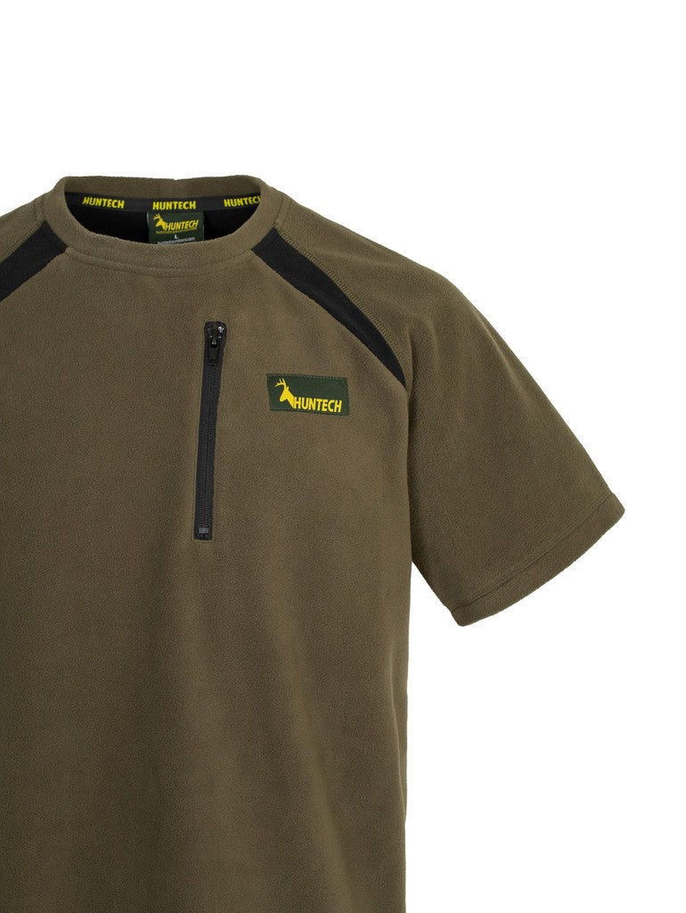 Close up of men’s bush tee in 180gsm high grade anti-pill finished fleece with standard crew neckline and is constructed using flatlock reinforced seams for strength and comfort, it features a zipped pocket and the Huntech logo on the left breast. Shown in military green. Ships from Australia.