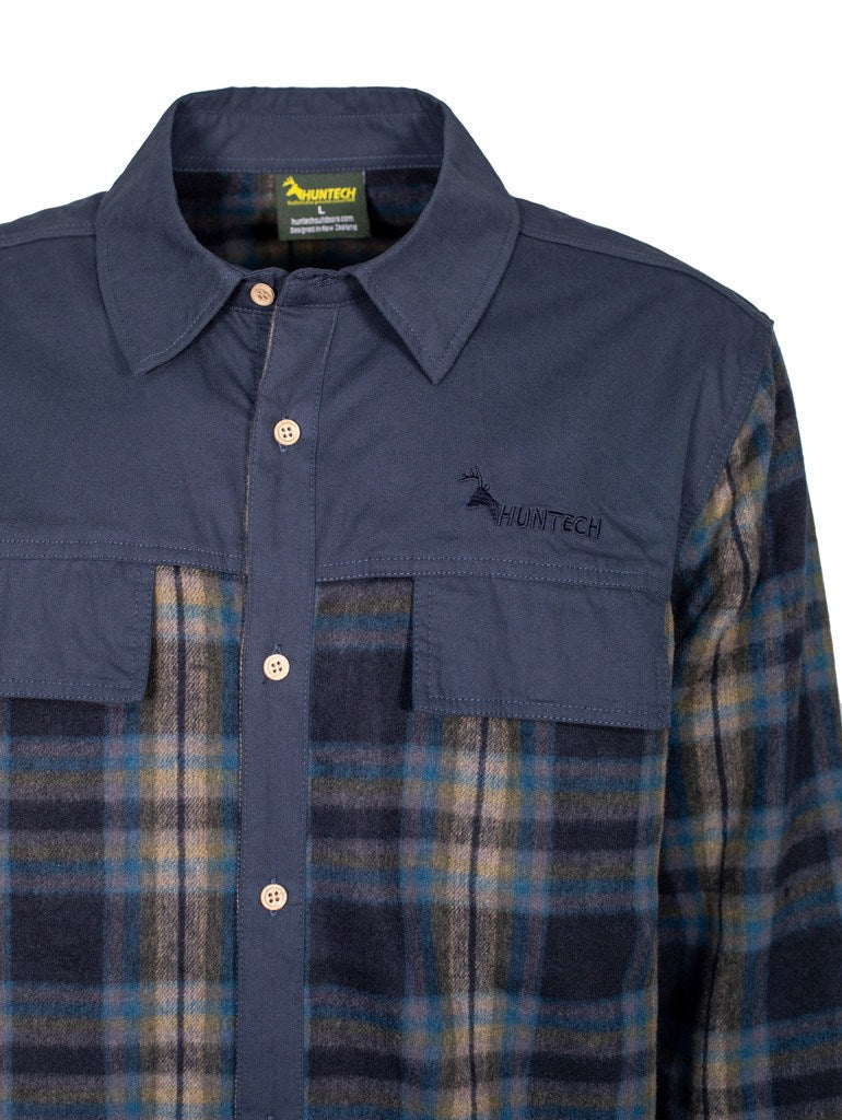 Close up of view of a tailored, lightweight and breathable men’s button shirt in a soft blue, yellow, pink and black checked jacquard cotton with a brushed finish. Features twin chest pockets with concealed closure and wooden buttons. Front and back yoke, collar, pocket flaps and button placket are in a navy blue.  Yoke has Huntech logo embroidered in matching navy cotton above left pocket. Ships from Australia.