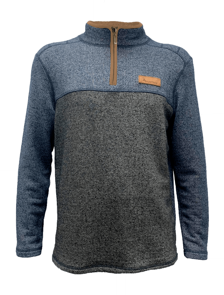 Front image of men's long sleeved knit sweater uses spliced jacquard knit design. Made from high-grade fabric and reinforced flatlock seams, it features a 1/4 zip and high collar with mid-brown leather trim on neckline. Left of yoke features Huntech logo embossed into leather panel. Ships from Australia. Shown in two tone denim / charcoal.