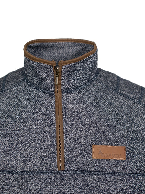 Close up detail of zipper and leather Huntech logo on front of the sweater. Shown in charcoal, this sweater ships from Australia.