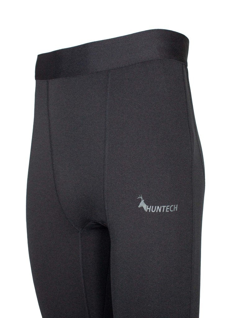 Three quarter front left close up of men’s slim fit, with seam details and Huntech logo in soft grey on side of left hip. Shown in black, these leggings ship from Australia.
