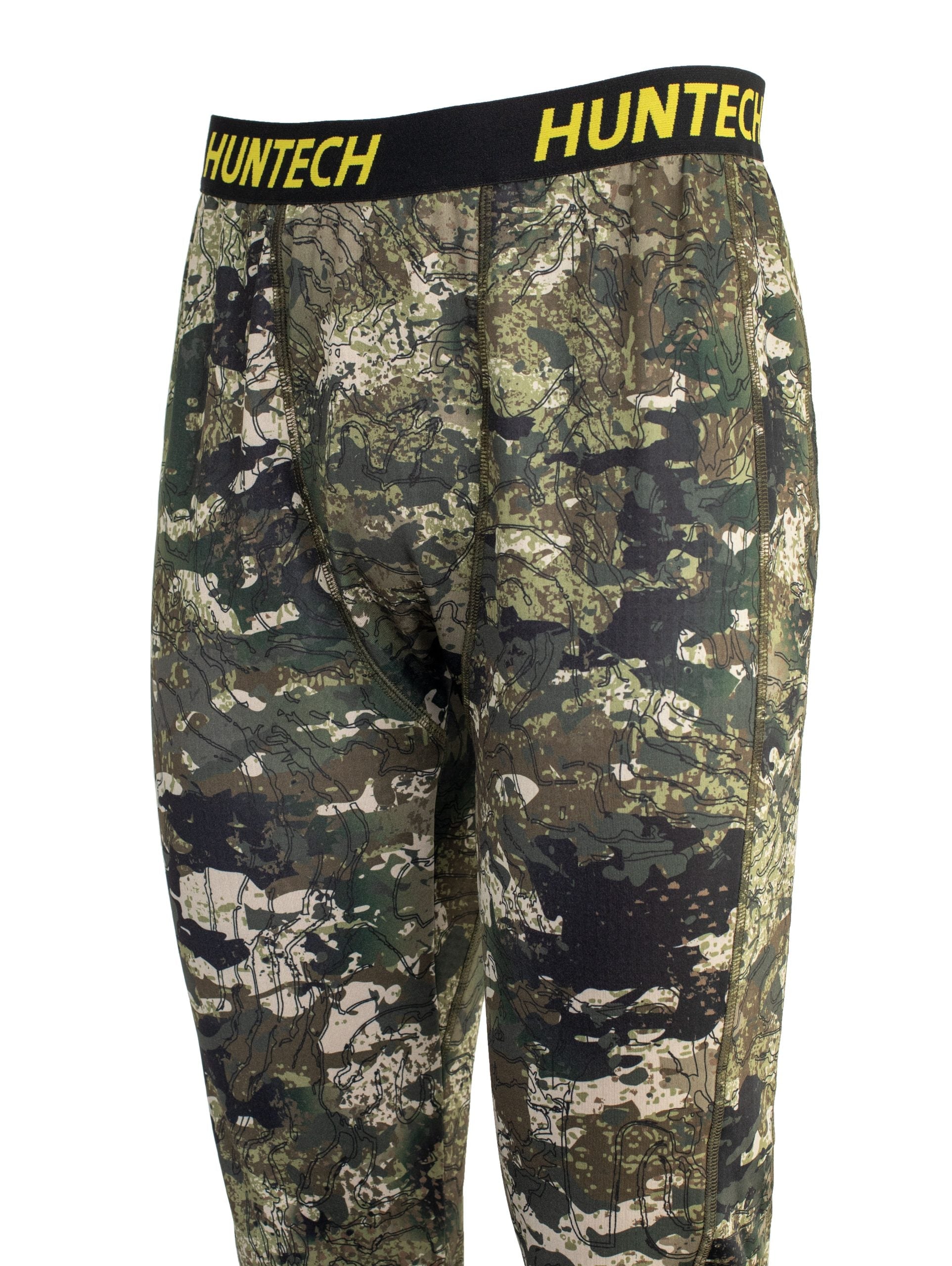 Close up of front three quarter view showing articulated panels and the black elastic waist band with the Huntech logo in yellow. Also shows articulated panels for performance.