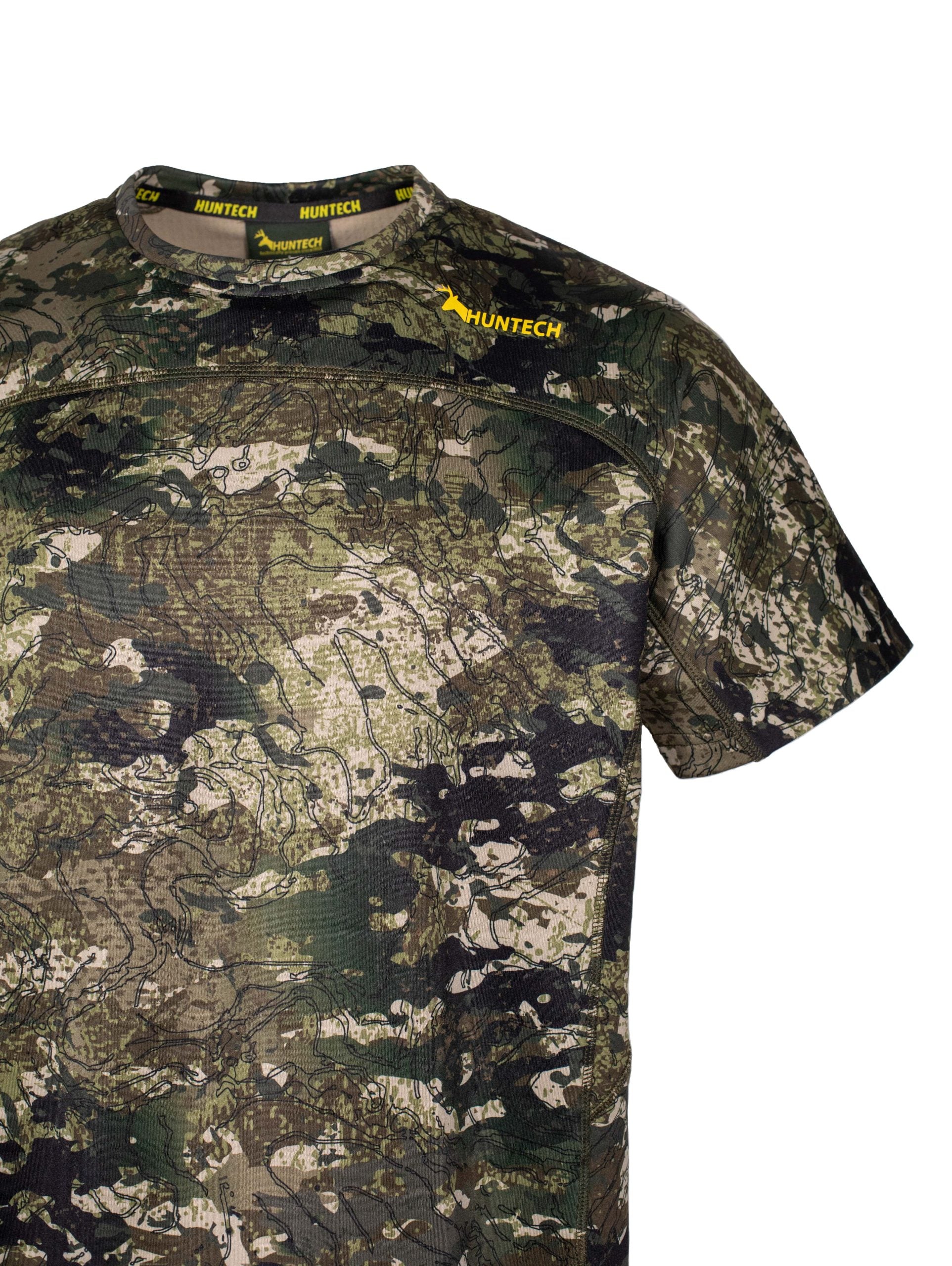 Close up of Huntech logo in yellow on front left of yoke. Shirt is in kakariki camo pattern.
