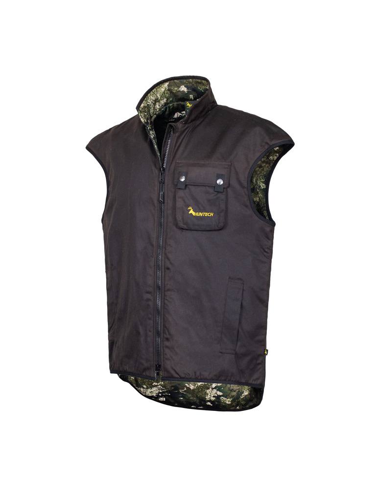 Three quarter front view of men’s zip-up oilskin vest with, fleece lining, chest pocket which features the Huntech logo in bright yellow and a dome closure, and a high tapered turtleneck. Designed with a super long tail, added shoulder width and collar height it’s offers protection when hauling out an animal on your back and has side pockets. Shown with kakariki camo lining, this vest ships from Australia.