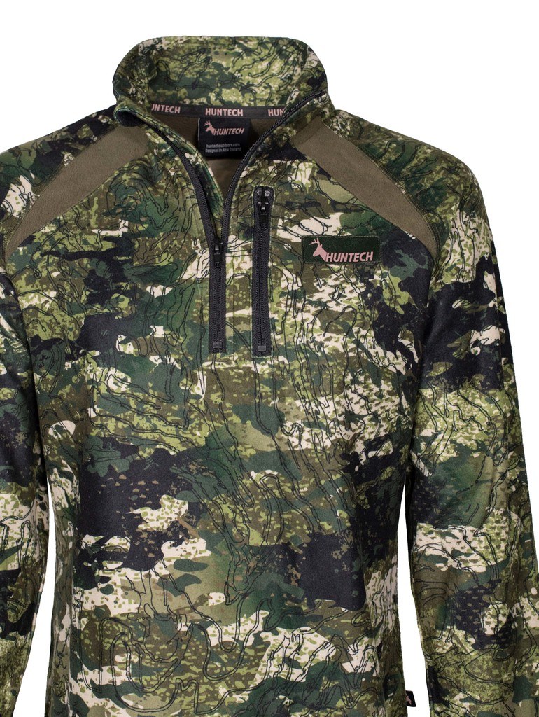 Close up of front view of women’s bush sweatshirt in 180gsm high grade anti-pill finished fleece with turtleneck, half zip entry and protective guard. It features the Huntech logo in rose gold on the breast. Shown in Kakariki camo pattern. Ships from Australia.