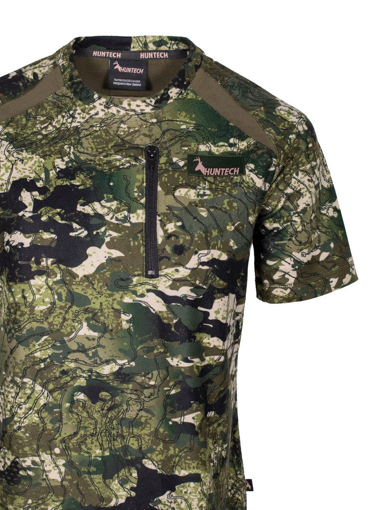 Close up of women’s bush tee in 180gsm high grade anti-pill finished fleece with standard crew neckline and is constructed using flatlock reinforced seams for strength and comfort, it features a zipped pocket and the Huntech logo in rose gold on the left breast. Shown in kakariki camo pattern. Ships from Australia.