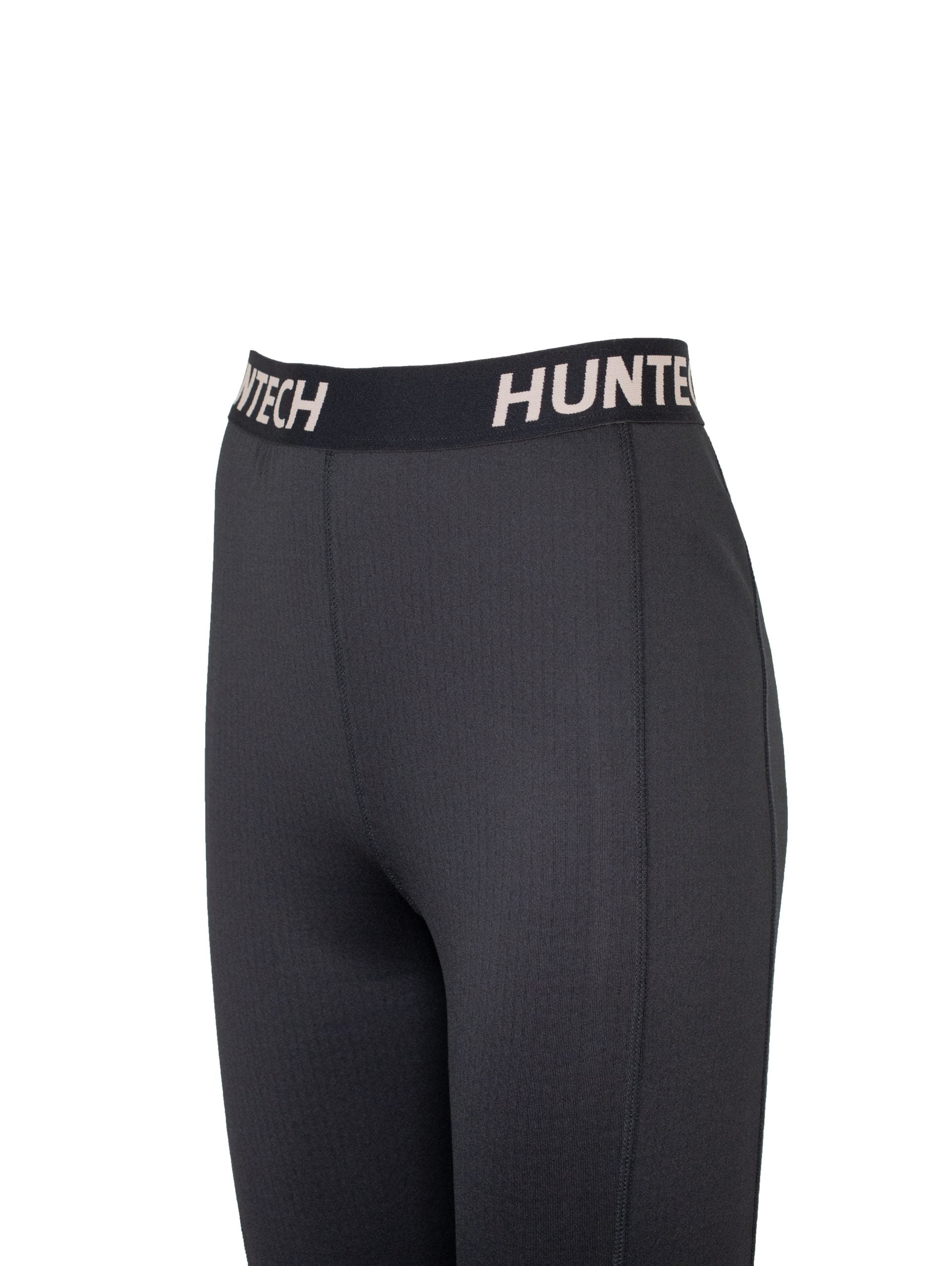 Close up of black waistband with Huntech logo. Shown on black leggings
