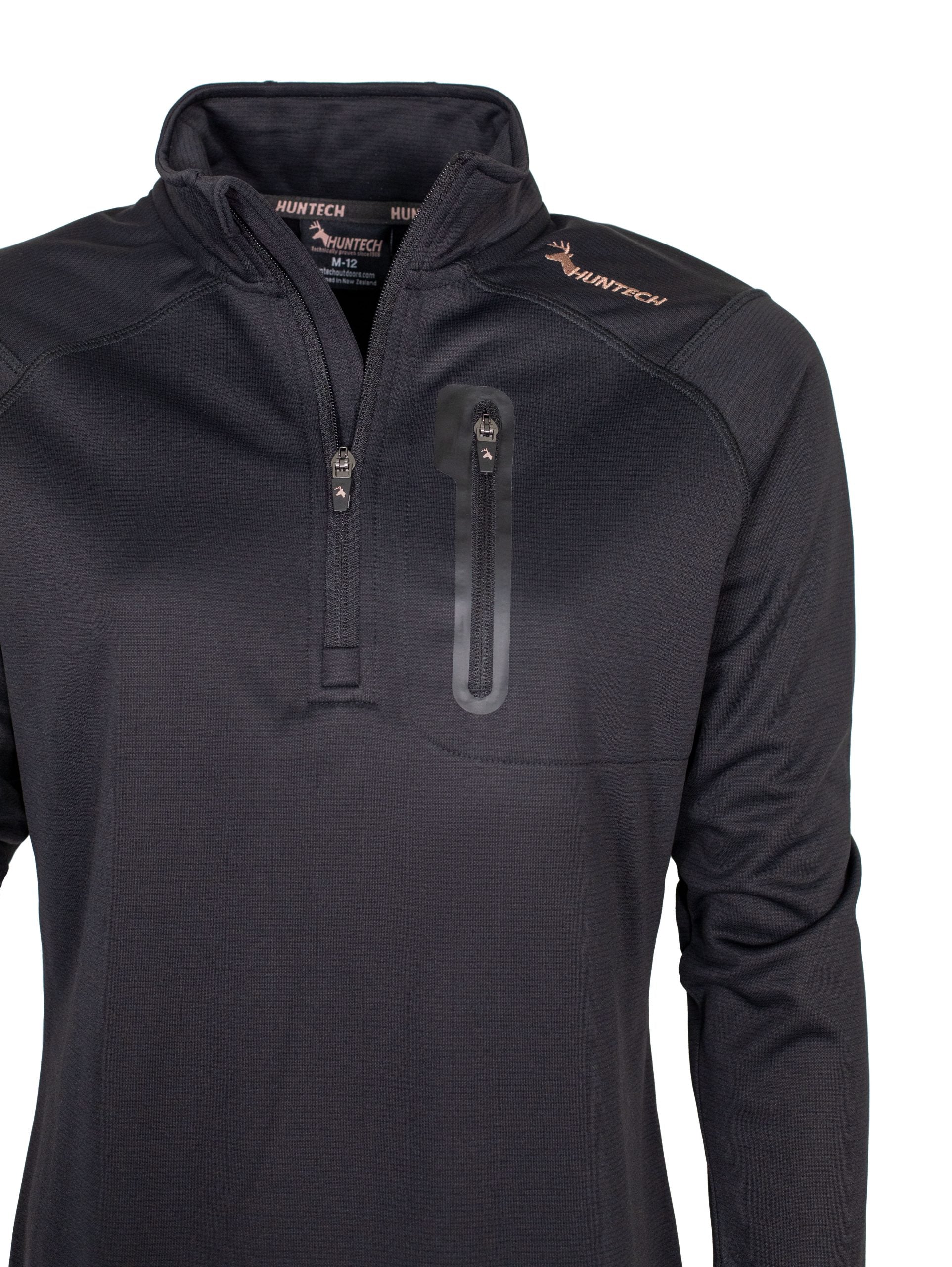Close up of zippered chest pocket, zip front closure and neckline. Huntech logo appears in rose gold on the shoulder. Shown here in black.