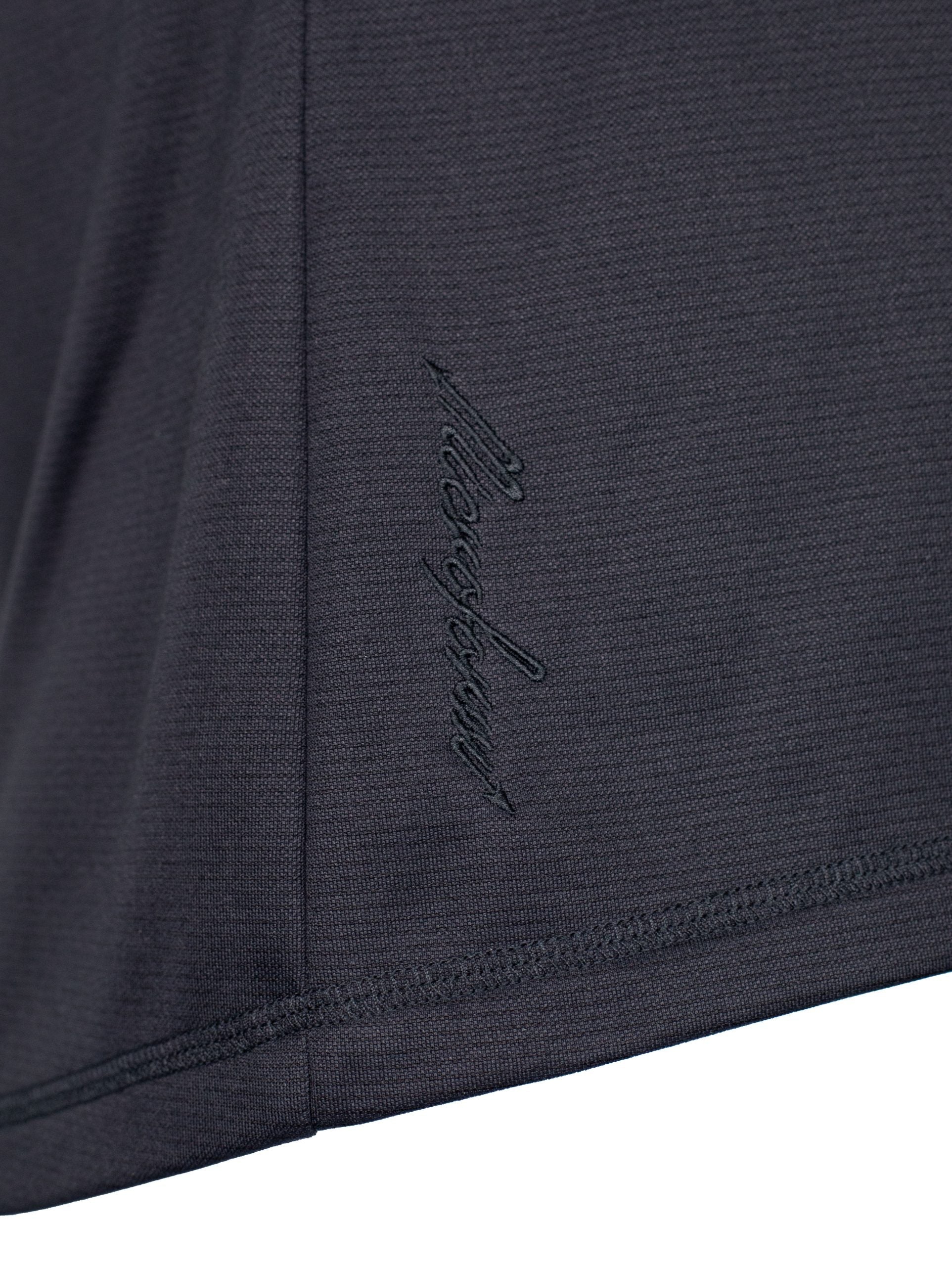 Close up of Microform fabric with named embroidered at bottom edge.