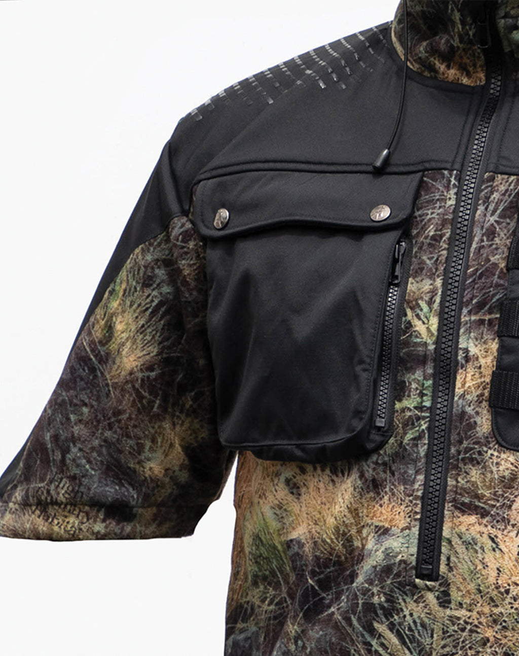 Close up of the right hand breast zip pocket on a Huntech \butcher coat in a hard-wearing, 330 gsm dual-grid fleece coats with a 500D coated Oxford nylon back overlay and shaped half sleeves that repel light showers. Shown in kakariki camo pattern, this coat ships from Australia.