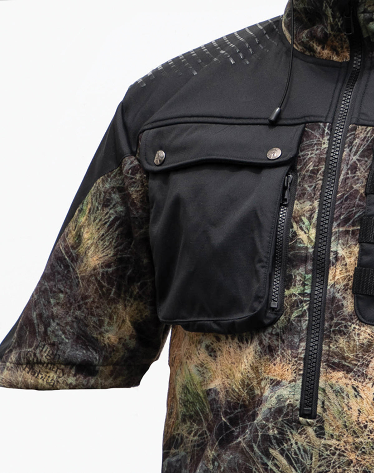 Close up of the right hand breast zip pocket on a Huntech \butcher coat in a hard-wearing, 330 gsm dual-grid fleece coats with a 500D coated Oxford nylon back overlay and shaped half sleeves that repel light showers. Shown in kakariki camo pattern, this coat ships from Australia.