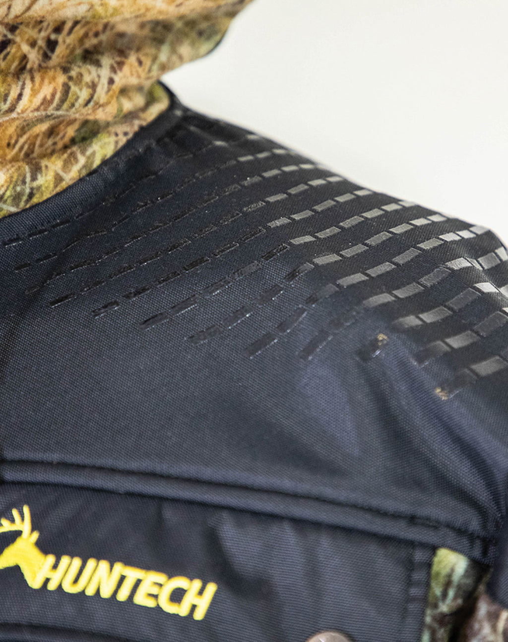 Close up of a Huntech butcher coat showing the 500D coated Oxford nylon back overlay. Shown in kakariki camo pattern, this coat ships from Australia.