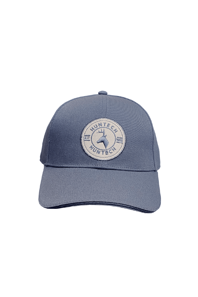 Front shot of mid blue 6 panel cap comes with a pre-curved brim and Velcro adjustment strap. One size fits most with a classic Huntech badge front and centre on this acrylic twill cap. Ships from Australia.
