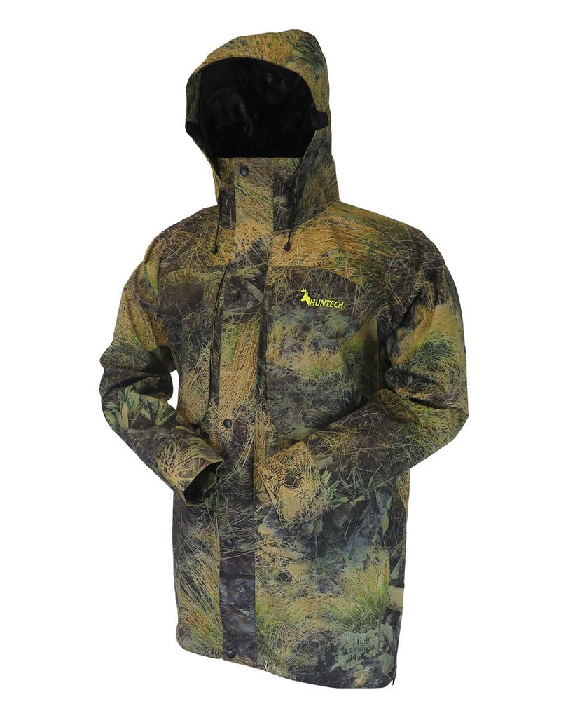 Front view of men’s breathable three-layer jacket with pit zips for heat regulation, YKK 2-way full length zip, thermal retention cuff and three-way adjustable hood. The jacket also features two bellowed chest pockets with the Huntech logo in bright yellow on the left pocket. Ships from Australia and is shown here in kakariki camo print with hood up.